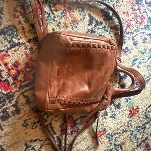 Mini brown leather backpack, lots of pockets inside.